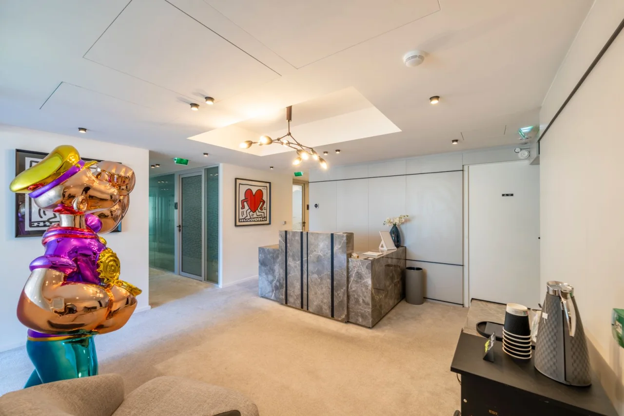 The Prime Offices Fontvieille reception with its marble desk and artworks